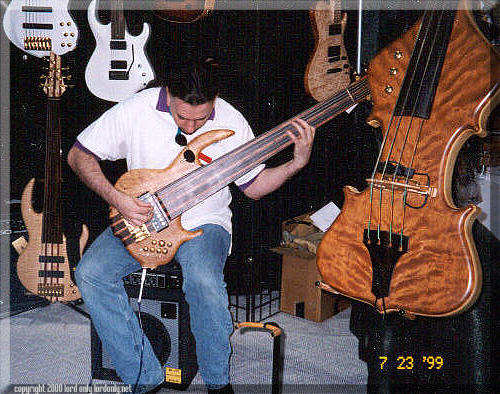 John plays his 8-string fretless at the Conklin Booth at the '99 Summer Namm show